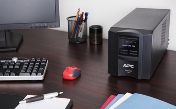 APC SMT750IC tower on desk from Specialist Power Systems